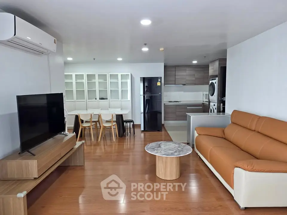 Spacious modern living room with open kitchen and stylish furniture