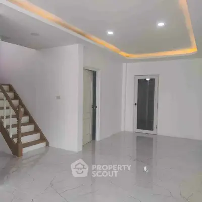 Spacious modern interior with marble flooring and elegant staircase