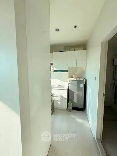 Compact kitchen with modern appliances and bright natural lighting