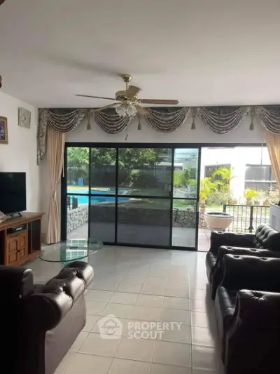 Spacious living room with pool view and elegant decor