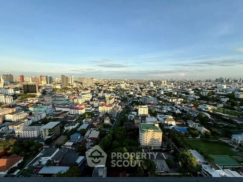 Stunning panoramic cityscape view from a high-rise building, showcasing urban skyline and vibrant neighborhood.