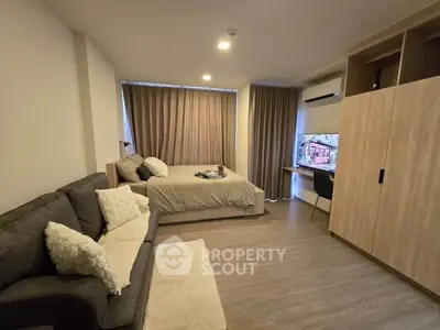 Modern studio apartment with cozy living area and stylish decor