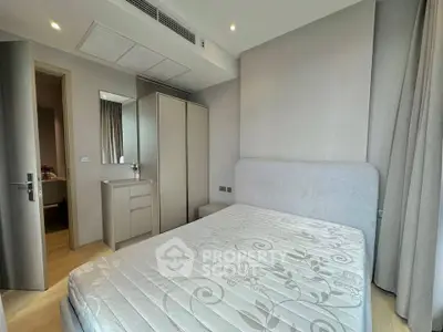 Modern bedroom with stylish furniture and natural light, perfect for comfortable living.