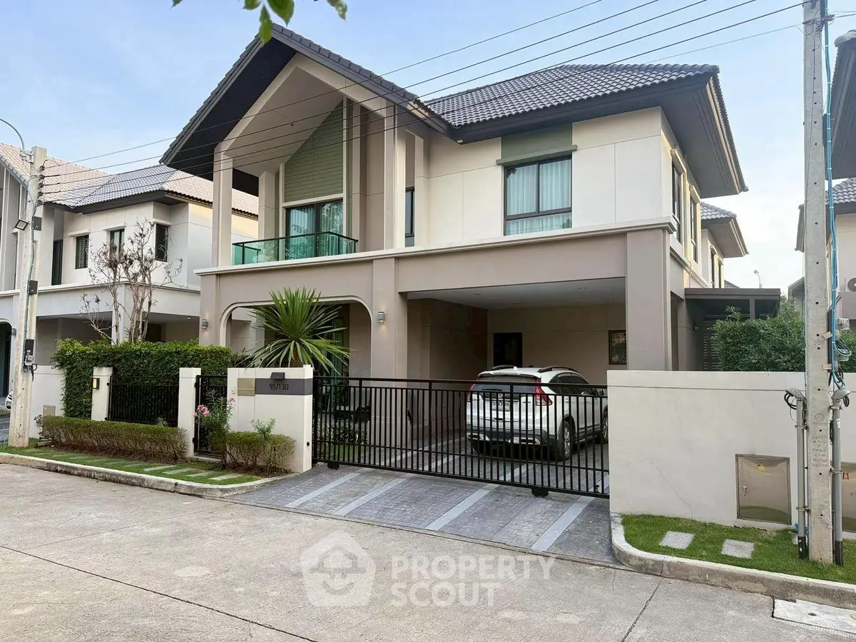 Modern two-story house with carport and landscaped front yard in suburban neighborhood.