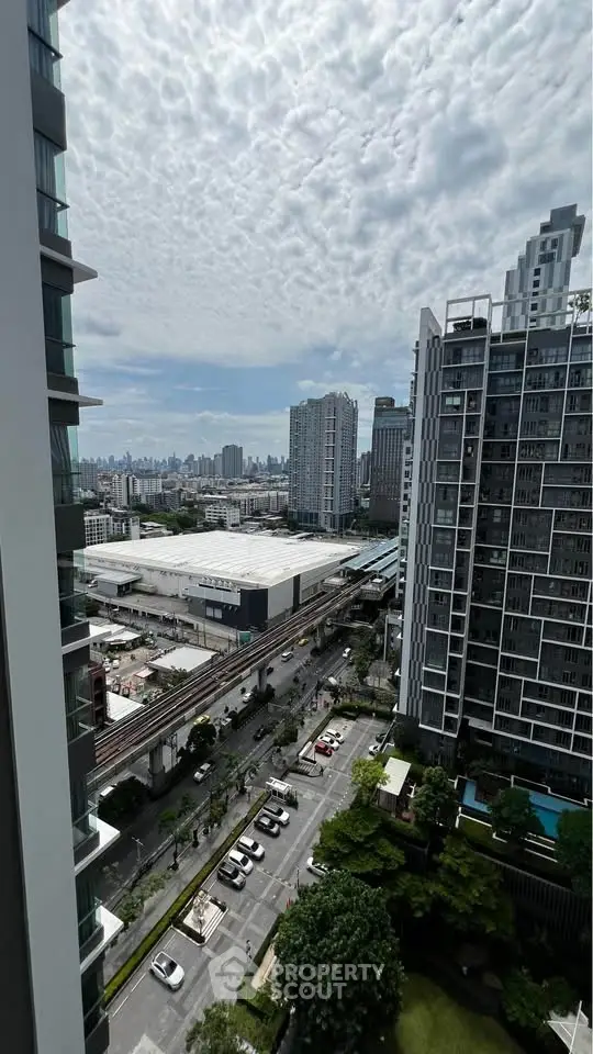 Stunning urban view from high-rise apartment overlooking cityscape and modern architecture.