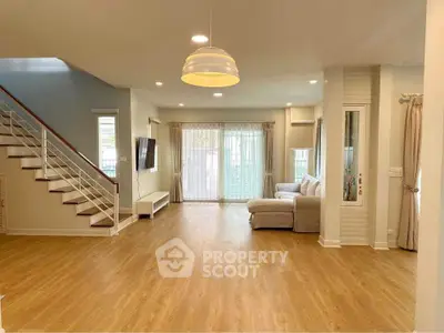 Spacious living room with modern decor and wooden flooring