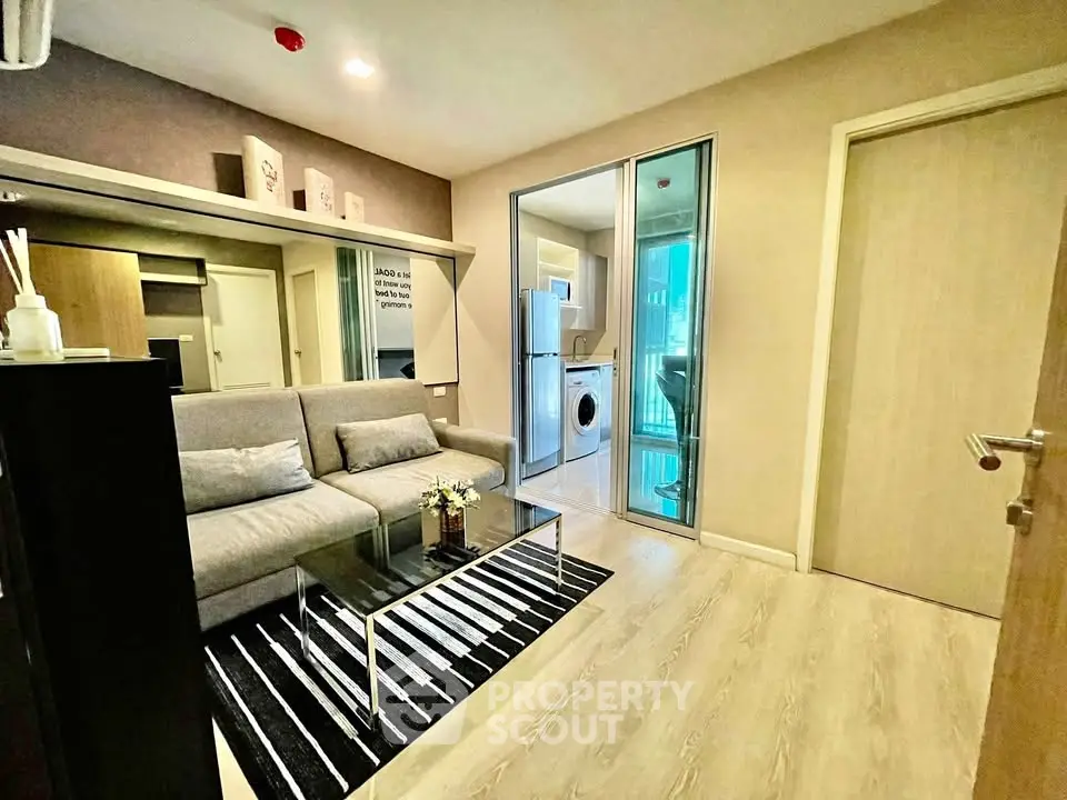 Modern living room with sleek design and adjacent laundry area