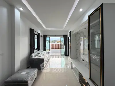 Modern living room with sleek design and large windows offering natural light.