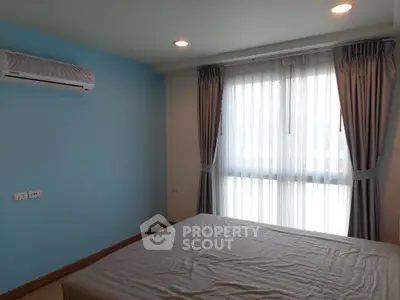 Cozy bedroom with natural light and air conditioning in modern apartment