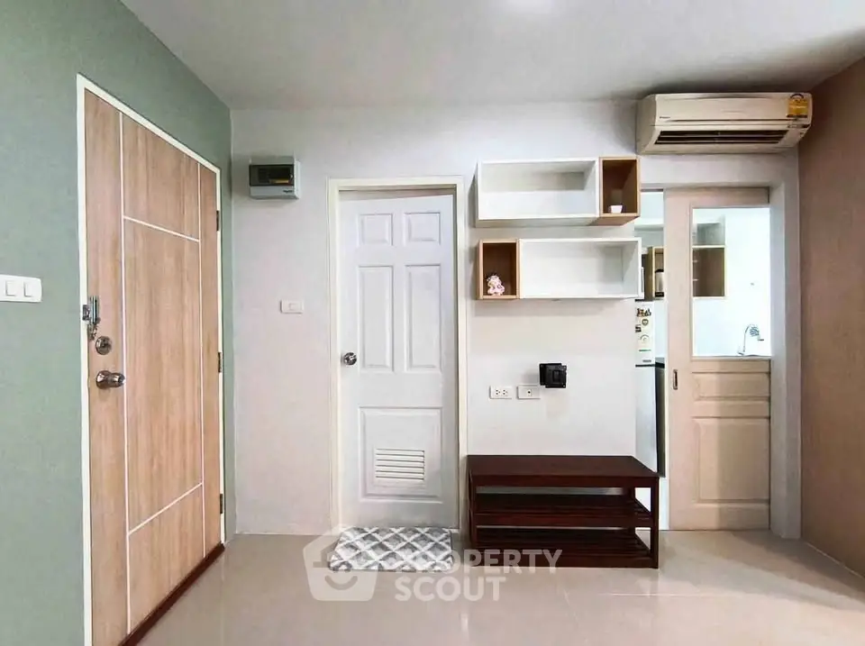 Modern apartment interior with sleek storage solutions and air conditioning unit.