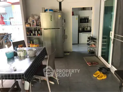 Spacious kitchen with modern appliances and dining area, perfect for family gatherings.