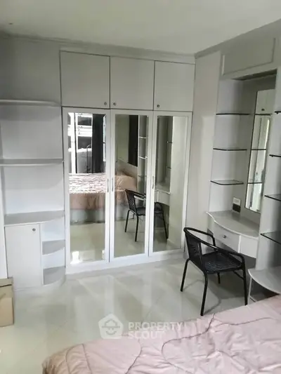 Spacious bedroom with built-in wardrobe and modern furnishings