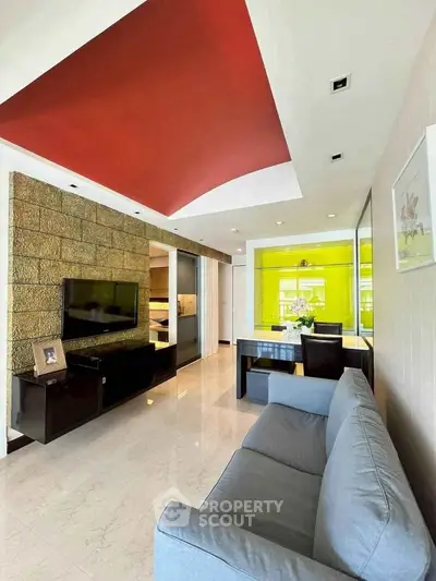 Modern living room with stylish red ceiling and sleek furniture