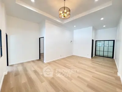 Spacious modern living room with elegant lighting and wooden flooring