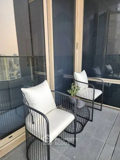Stylish balcony with modern seating and city view, perfect for relaxation and enjoying the skyline.