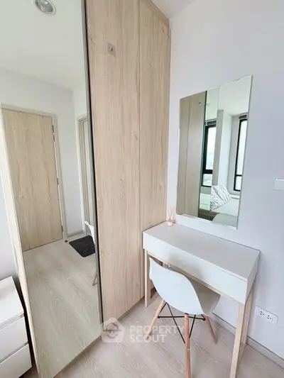 Modern bedroom with sleek wardrobe and minimalist desk setup