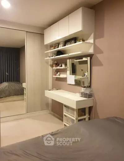 Modern bedroom with stylish vanity and mirrored wardrobe