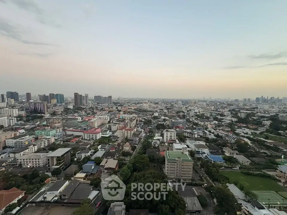 Stunning panoramic cityscape view from a high-rise building at sunset.
