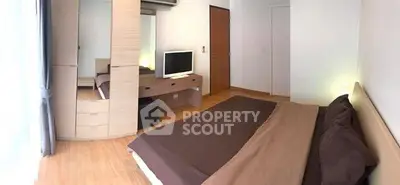 Spacious bedroom with modern furniture and natural light