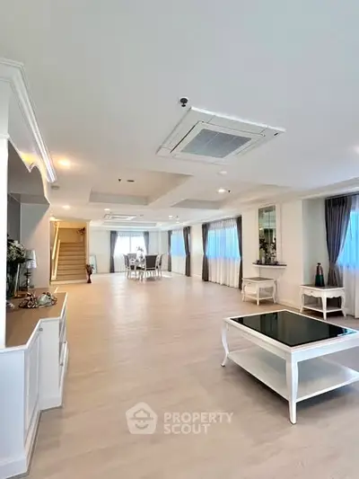 Spacious and elegant living room with modern decor and ample natural light