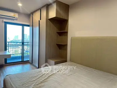 Modern bedroom with balcony view and stylish wooden wardrobe in urban apartment