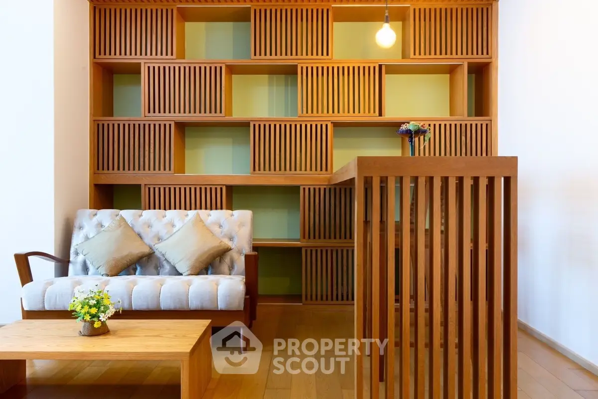 Modern living room with stylish wooden furniture and unique shelving design.