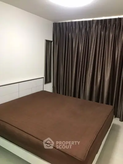 Cozy bedroom with modern decor and large window curtains