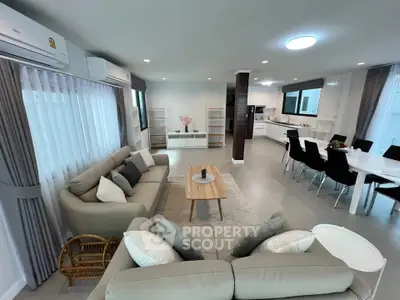 Spacious open-plan living room with modern kitchen and elegant decor