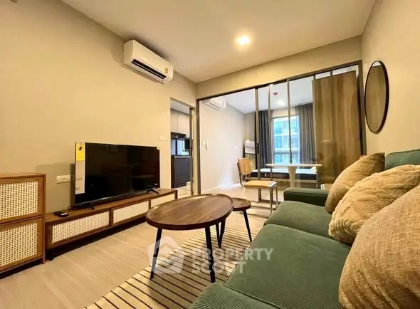 Modern living room with stylish furniture and open layout, featuring a cozy ambiance.