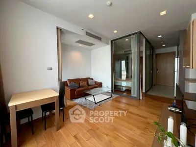 Modern living room with wooden flooring and stylish furniture in a cozy apartment.