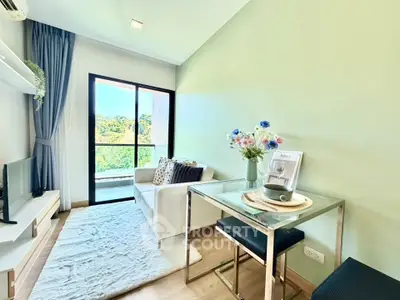 Charming living room with balcony view, modern decor, and cozy seating area in a stylish apartment.