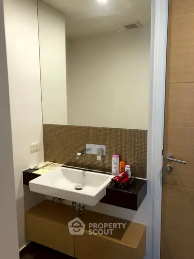 Modern bathroom with sleek sink and wooden cabinetry