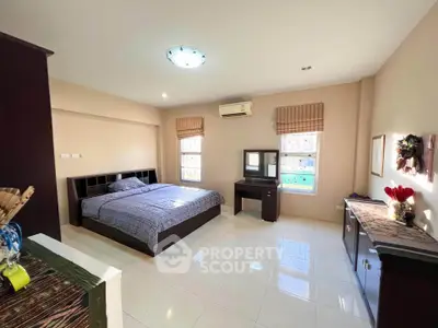 Spacious bedroom with modern furnishings and ample natural light