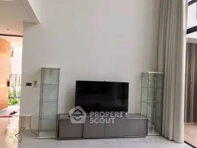 Spacious modern living room with high ceilings and sleek TV setup