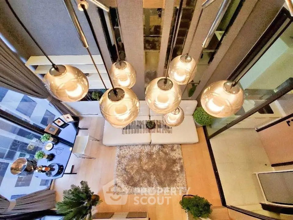 Stunning modern living room with high ceiling and elegant lighting fixtures