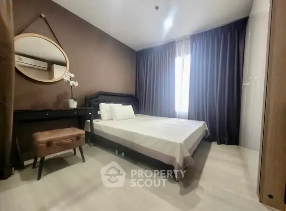 Cozy bedroom with modern decor and ample natural light