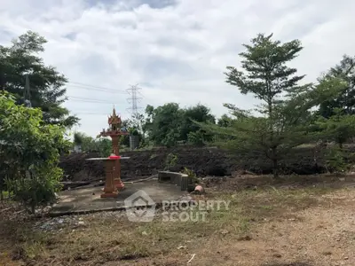 Spacious land plot with lush greenery and potential for development.