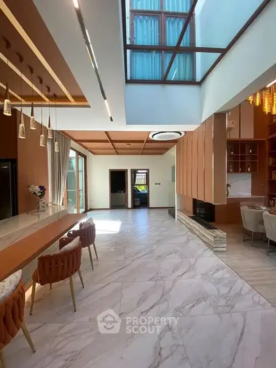 Luxurious open-plan living area with high ceilings and elegant decor