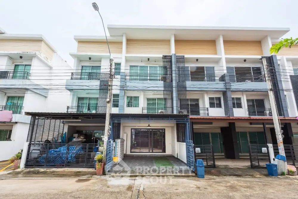 Modern townhouse exterior with clean lines and spacious balconies