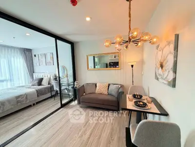 Modern living room with stylish decor and open view into cozy bedroom