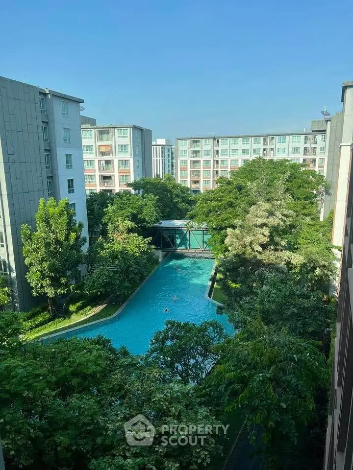 Stunning apartment view with lush greenery and inviting pool area.