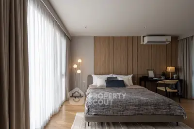 Elegant bedroom with modern decor and large window drapes