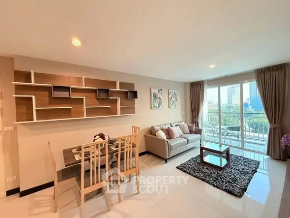Spacious modern living room with elegant decor and city view balcony.