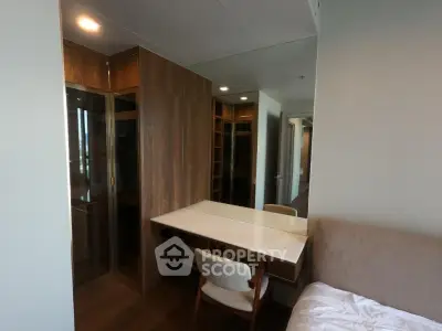 Modern bedroom with stylish wooden wardrobe and cozy study area