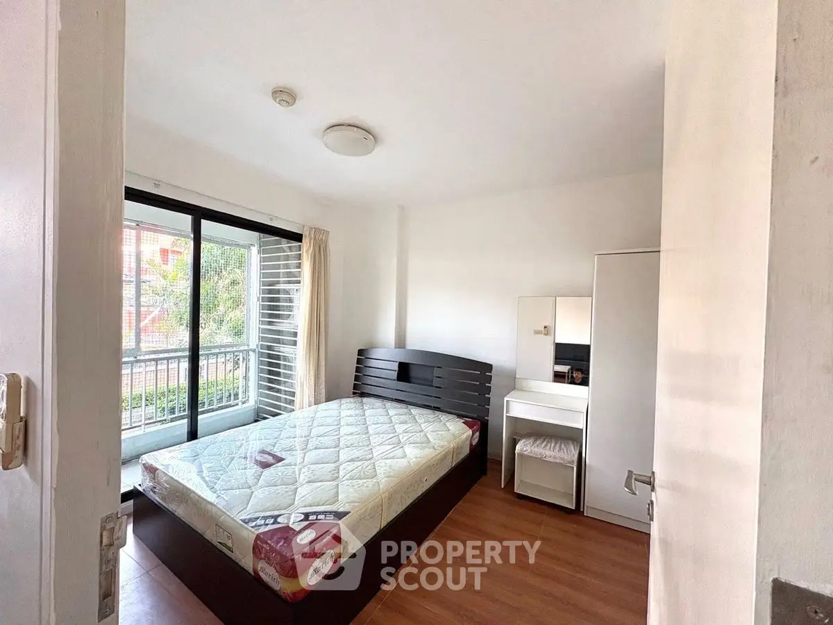 Cozy bedroom with large window and modern furnishings