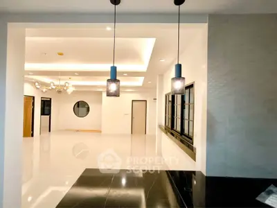 Spacious modern living room with elegant lighting and sleek design