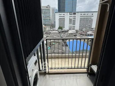 Urban balcony with city view and washing machine, perfect for modern living.