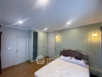 Spacious bedroom with elegant lighting and built-in wardrobe