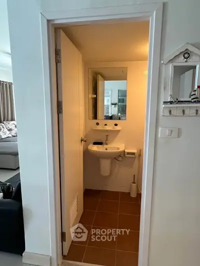 Compact bathroom with modern fixtures in a cozy apartment setting.