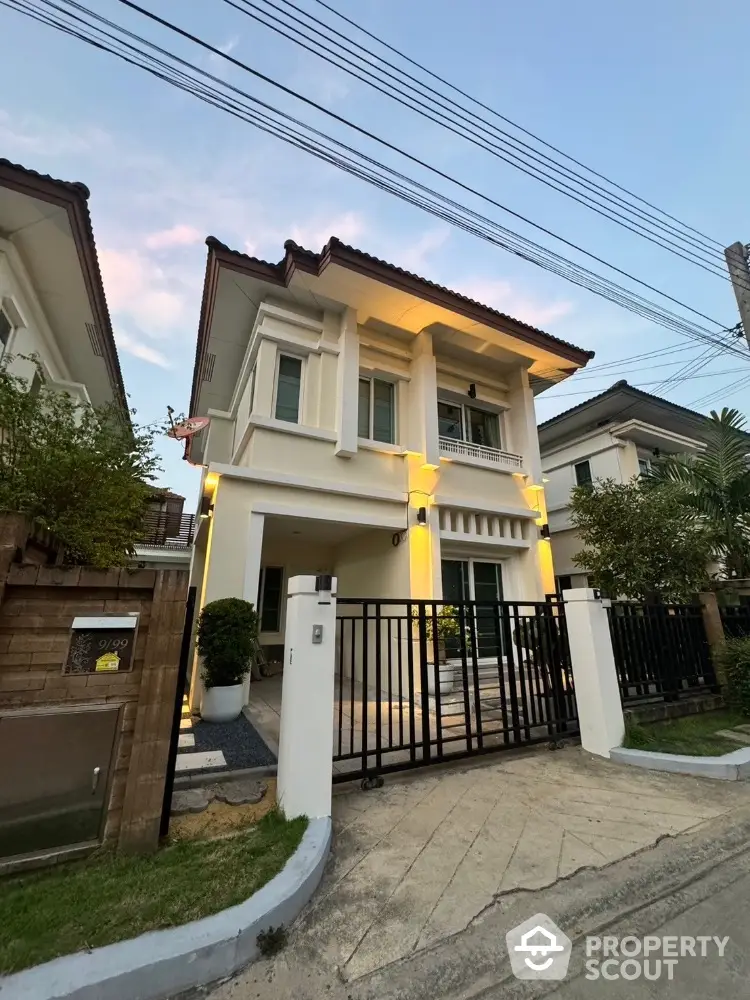 Charming two-story house with modern design and gated entrance in serene neighborhood